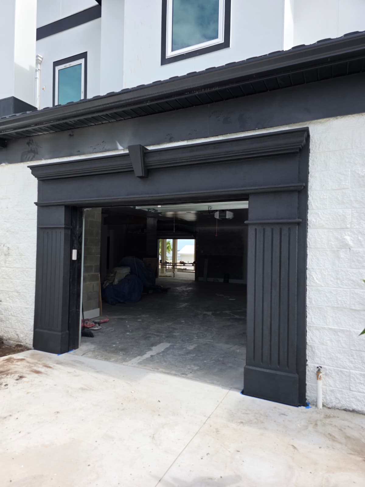Dark stucco garage surround with fluted columns